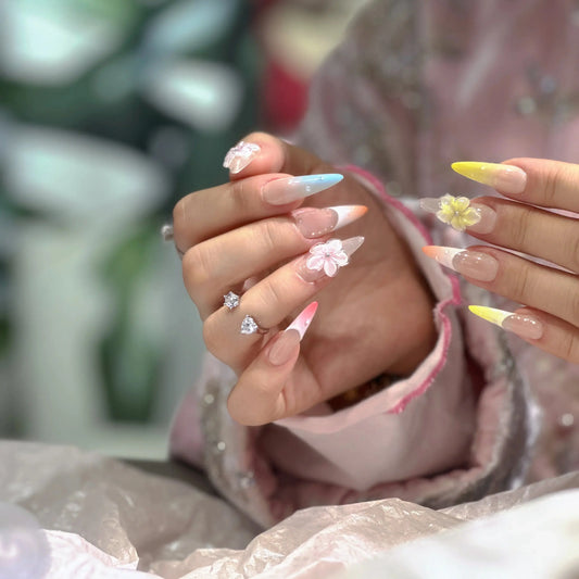 Close-up of the 3D floral accents on the pastel spring nails.