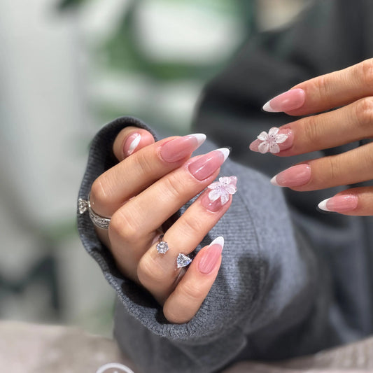 Close-up of the sakura flower artwork on the spring-themed nails.