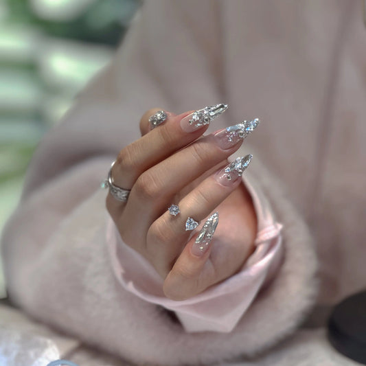 Close-up of the silver star accents and metallic glitter on the nails.