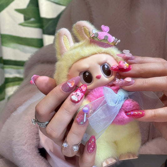 Close-up of the playful 3D cartoon charm on the press on nails.