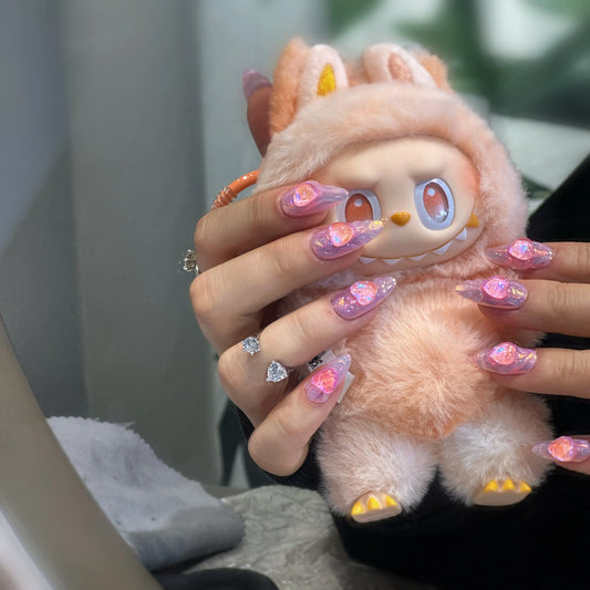 Close-up of the 3D heart sculptures on the pink ombre press on nails.