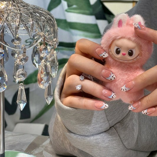 Close-up of the chocolate crumb texture on the French tip nails.