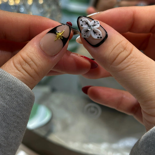 Close-up of the black calligraphy lines on the mocha nude press on nails.