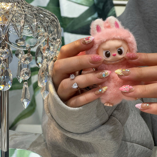 Close-up of the iridescent shell texture detail on the coastal-themed nails.