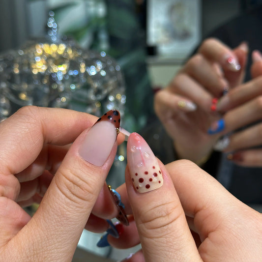 Close-up of the delicate snowflake designs on the winter-themed nails.