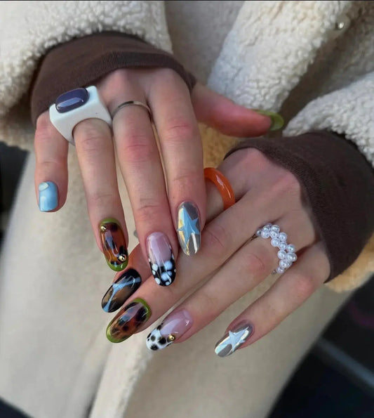 Colorful press on nails with star, tortoiseshell, and leopard designs from Tsuki Nails