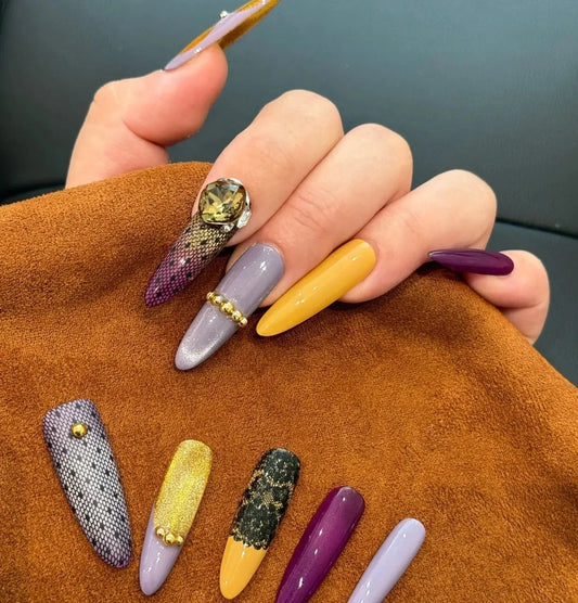 Salon-quality Tsuki Nails press on nails in purple, yellow, and lace designs with gems.