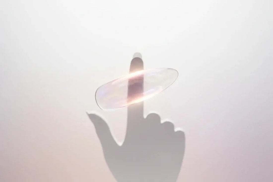 Iridescent press-on nail glowing above a finger silhouette, Tsuki Nails healthy manicure