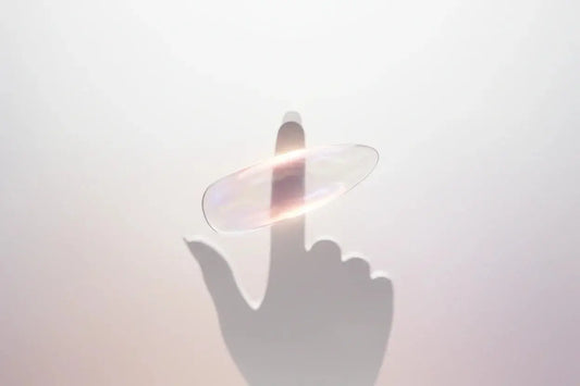 Iridescent press-on nail glowing above a finger silhouette, Tsuki Nails healthy manicure