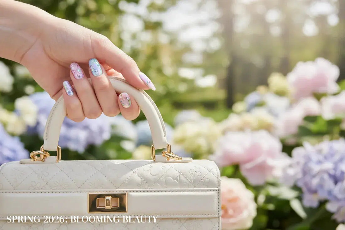 Pastel floral press on nails holding designer white bag, spring garden background, Tsuki Nails