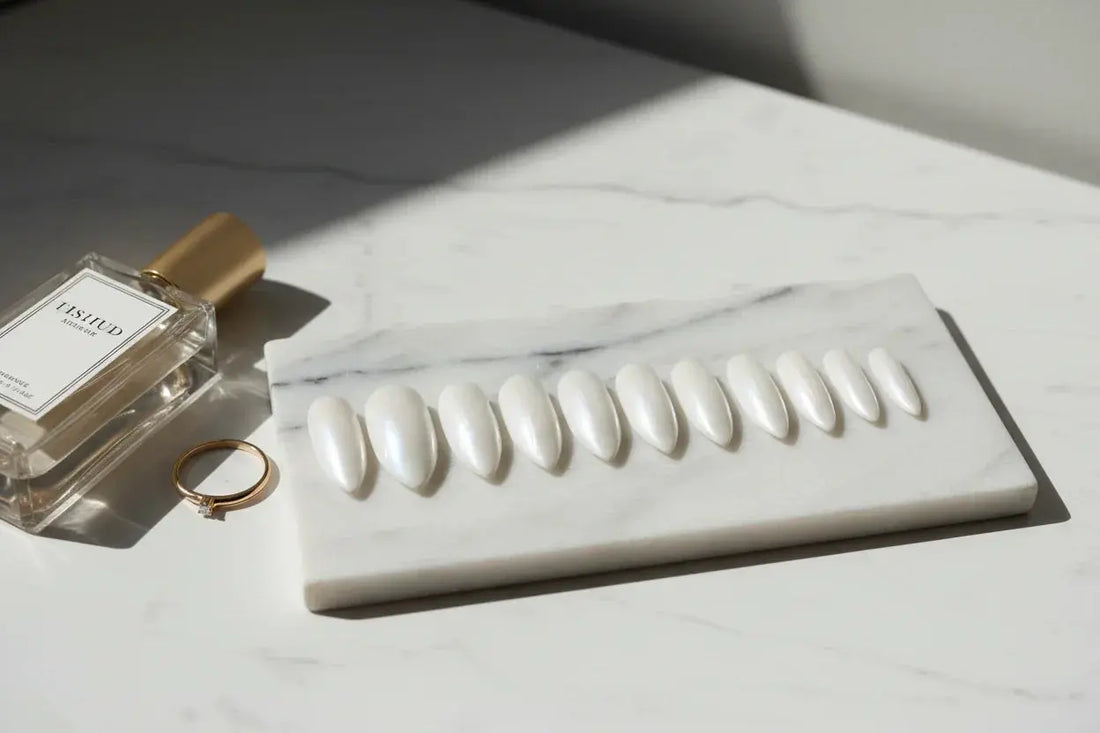 Glossy white press on nails on marble with perfume and ring, luxury Tsuki Nails aesthetic