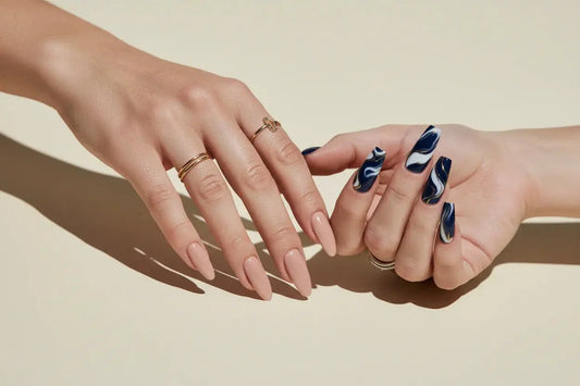 Two hands with Tsuki Nails press on nails: one with nude almond nails, one with blue marble square nails.