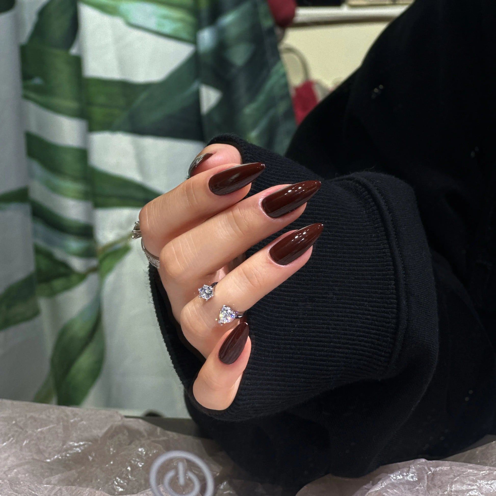 Model wearing the Crimson Crown stiletto nails, showcasing the bold and regal style on hands.

