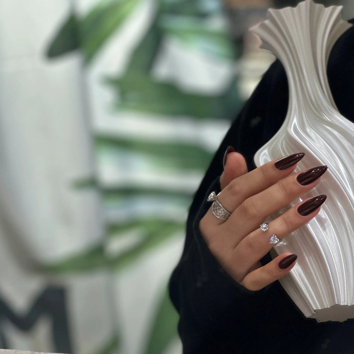 Side view highlighting the sharp point and sleek silhouette of the Crimson Crown stiletto nails.

