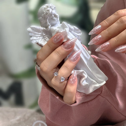 White polka dots and sheer nude-pink translucent finish on the celestial press on nails.

