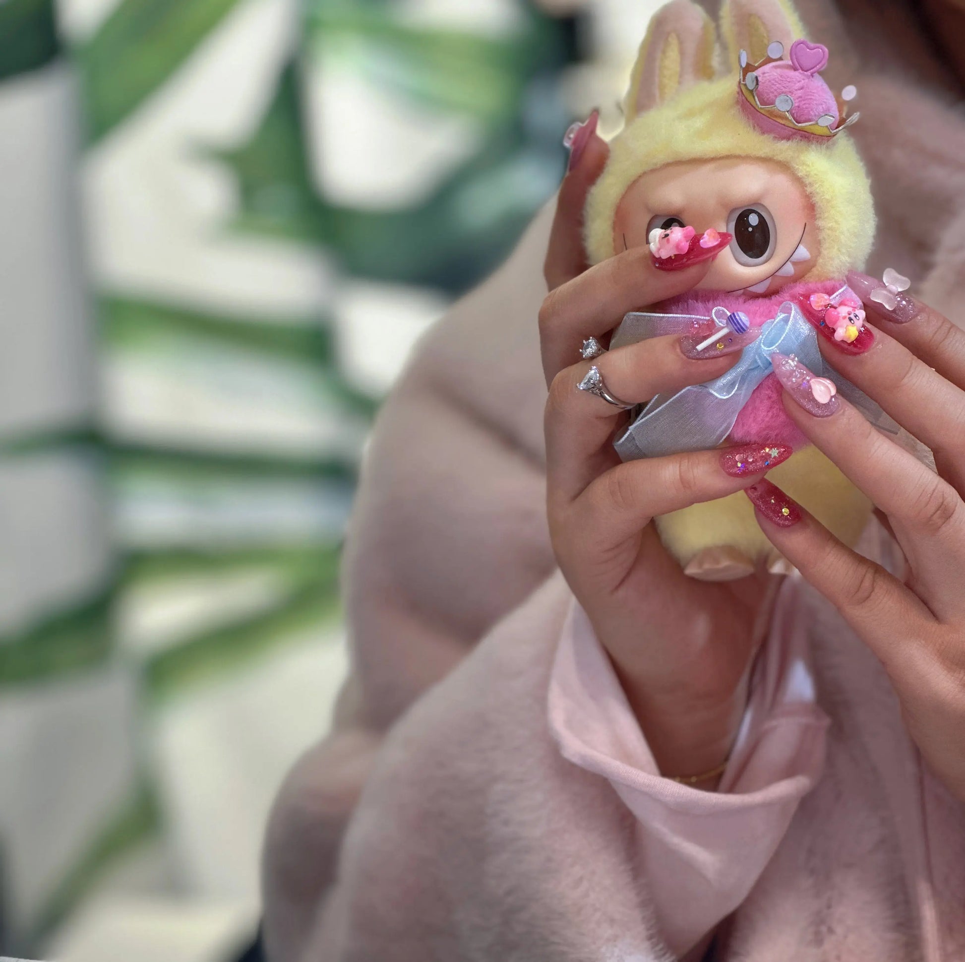 Iridescent rainbow heart details on the Kirby-themed nails.

