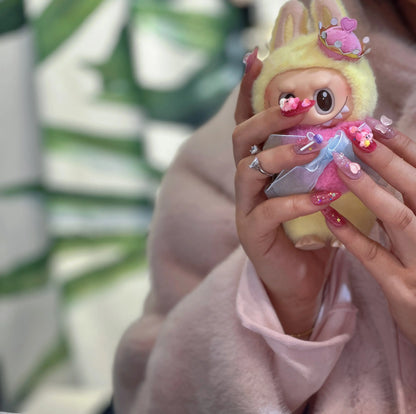 Iridescent rainbow heart details on the Kirby-themed nails.

