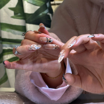 Hand-painted blossom details on the serene press on nails.

