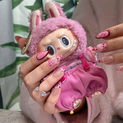 Close-up of the hand-placed flowers and pearl dewdrops on the nails.

