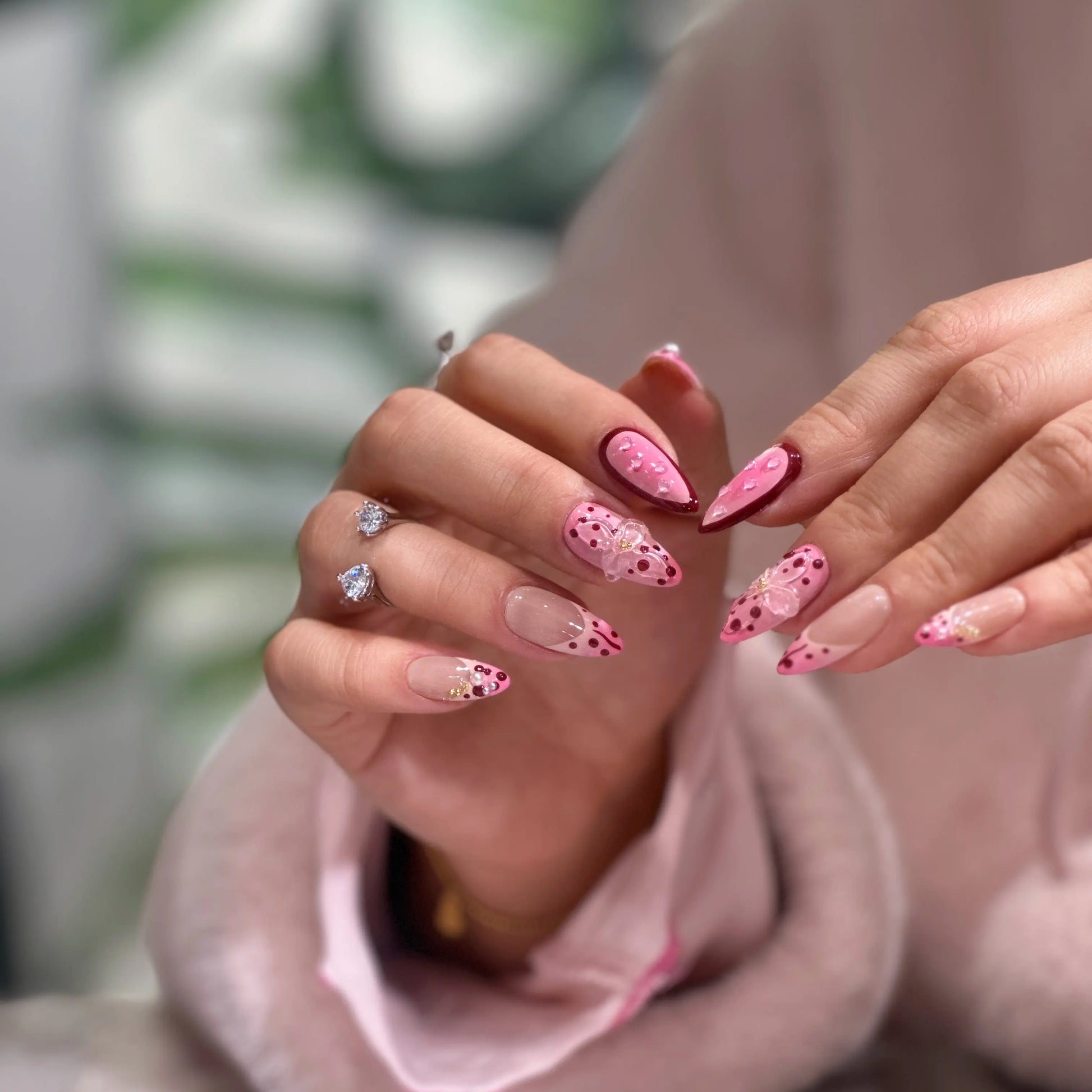 Ombre pink petals color gradient detail on the garden-themed press on nails.

