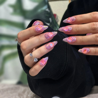 Romantic manicure with Aurora Heart 3D heart press on nails worn on hand.

