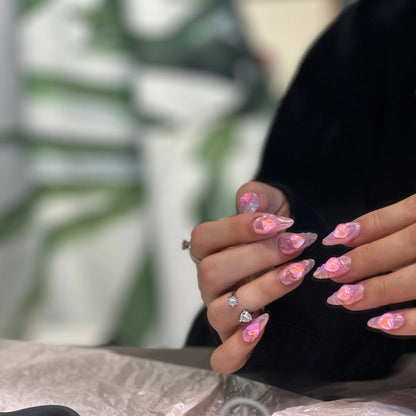 Iridescent shimmer and glossy finish detail on the Aurora Heart nails.

