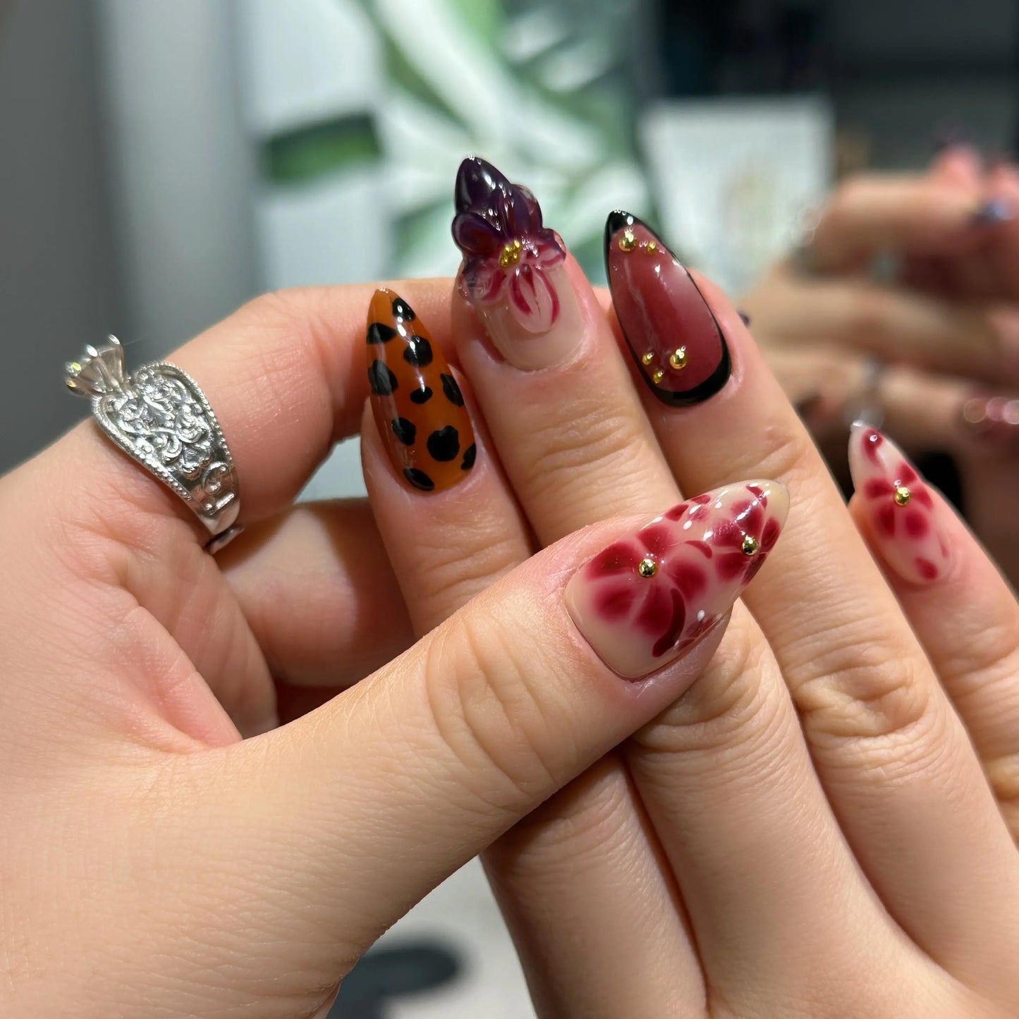 Close-up of the rich oxblood and violet ombre gradient on the nails.