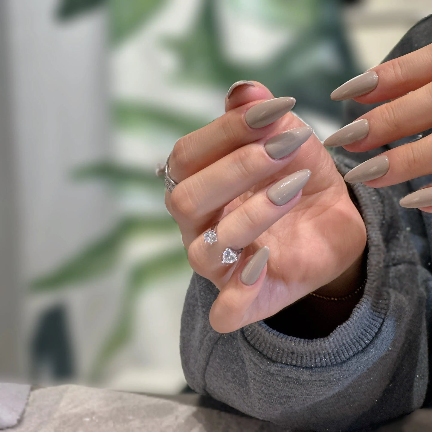 Side view showcasing the sharp stiletto silhouette of the Grey Muse nails.

