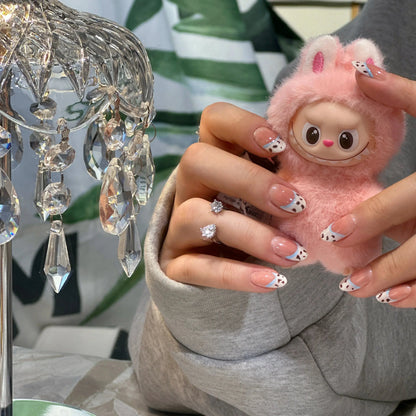Close-up of the chocolate crumb texture on the French tip nails.


