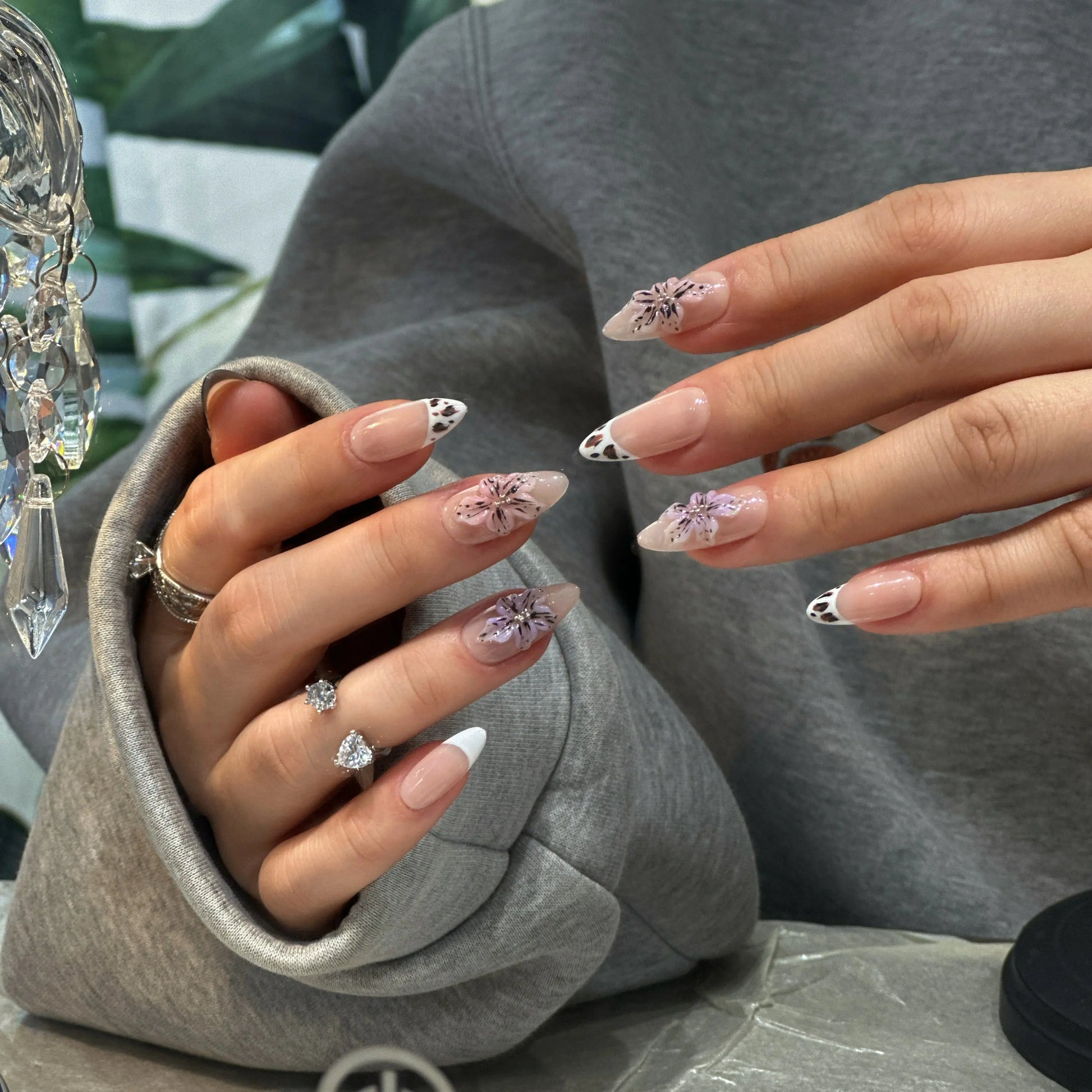 Close-up of the black calligraphy line work on the mocha-nude press on nails.

