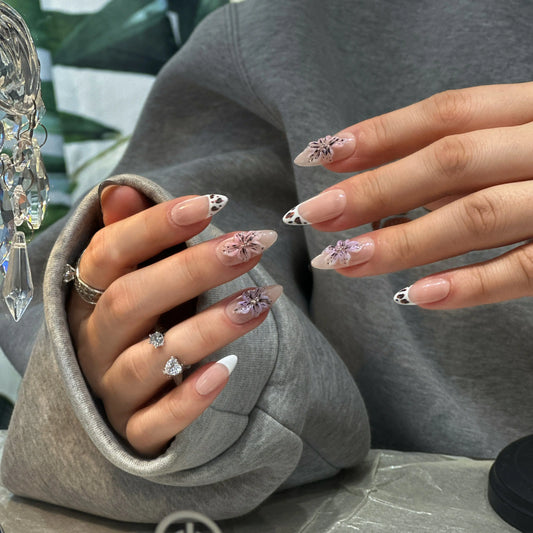 Close-up of the black calligraphy line work on the mocha-nude press on nails.

