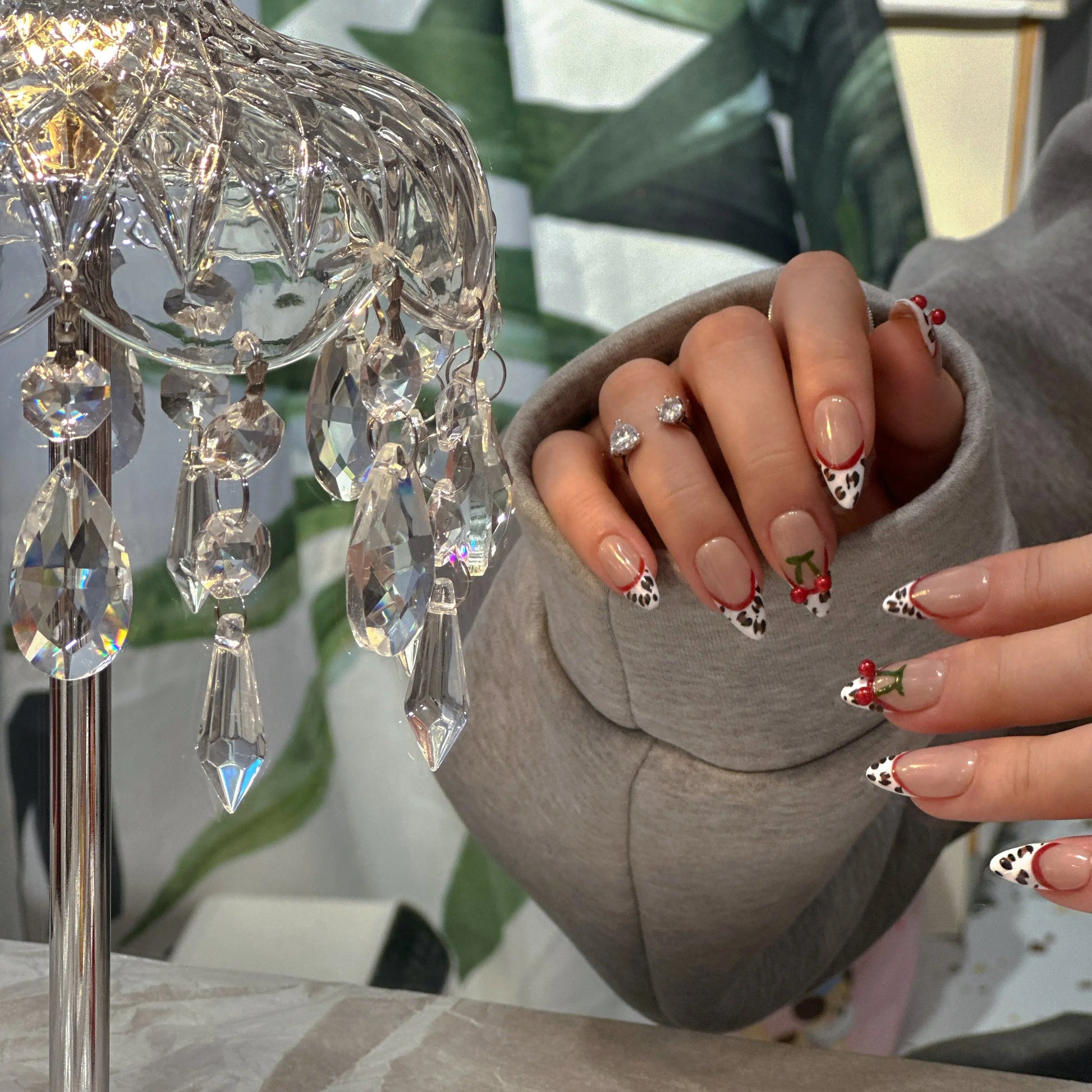 Crisp white French tips on mocha nude base with leopard design.

