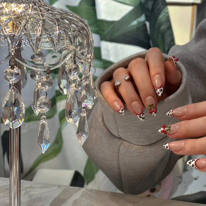 Crisp white French tips on mocha nude base with leopard design.

