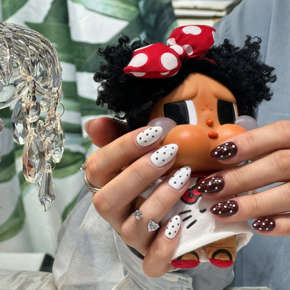 Set of reusable press on nails showing both white and brown base with polka dots