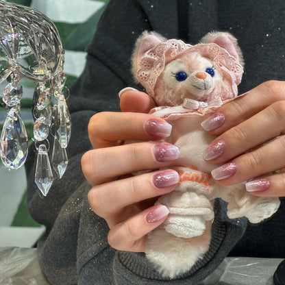 Dreamy and soft manicure with Pink Mist ombre glitter press on nails.


