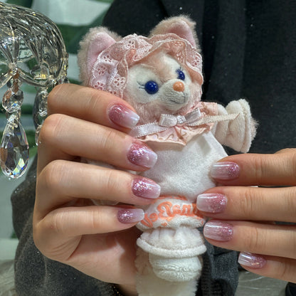 Close-up of the soft gradient from warm rose to ethereal white on the nails.

