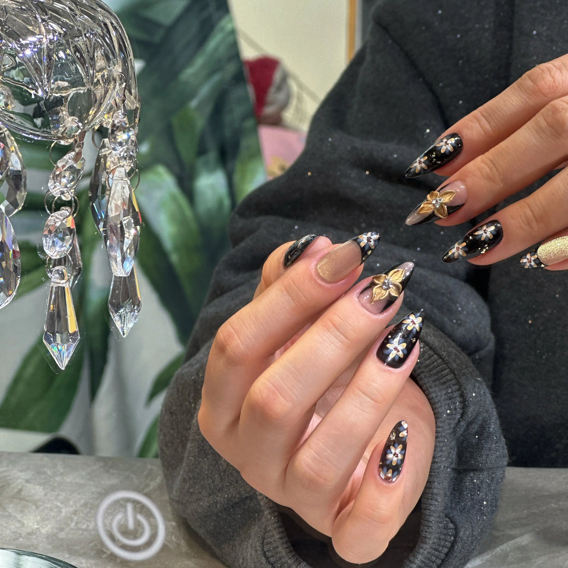 Shiny, high-gloss finish on the black press on nails, reflecting light like raven feathers.