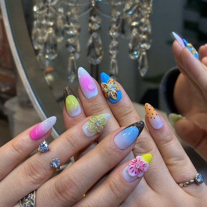 Hand modeling Rainbow Garden nails displaying vibrant rainbow gradients with pink, blue, yellow, green and purple ombre
