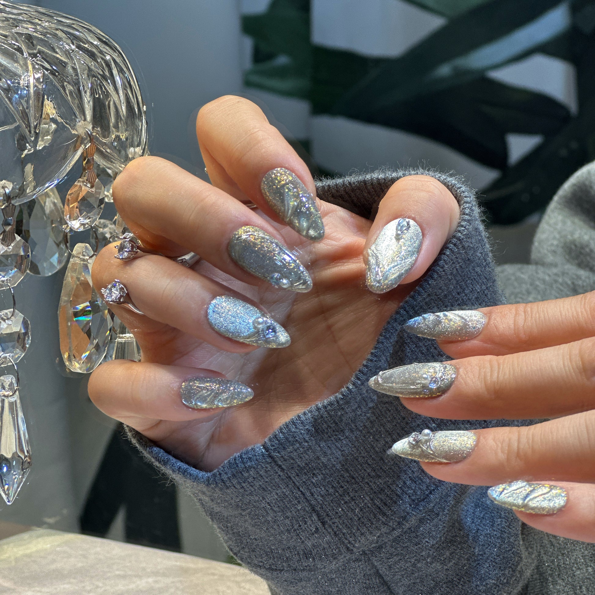 Both hands wearing Silver Feather nails showing complete angelic design with silver glitter and feather patterns

