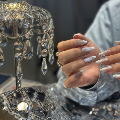 Both hands clasped wearing Pearl French Shimmer nails with champagne silver glitter and white French tip contrast
