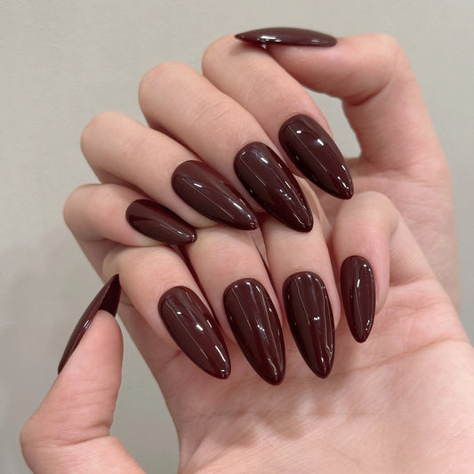 Crimson Crown press on nails, full set of sharp stiletto nails in a deep burgundy-brown color.

